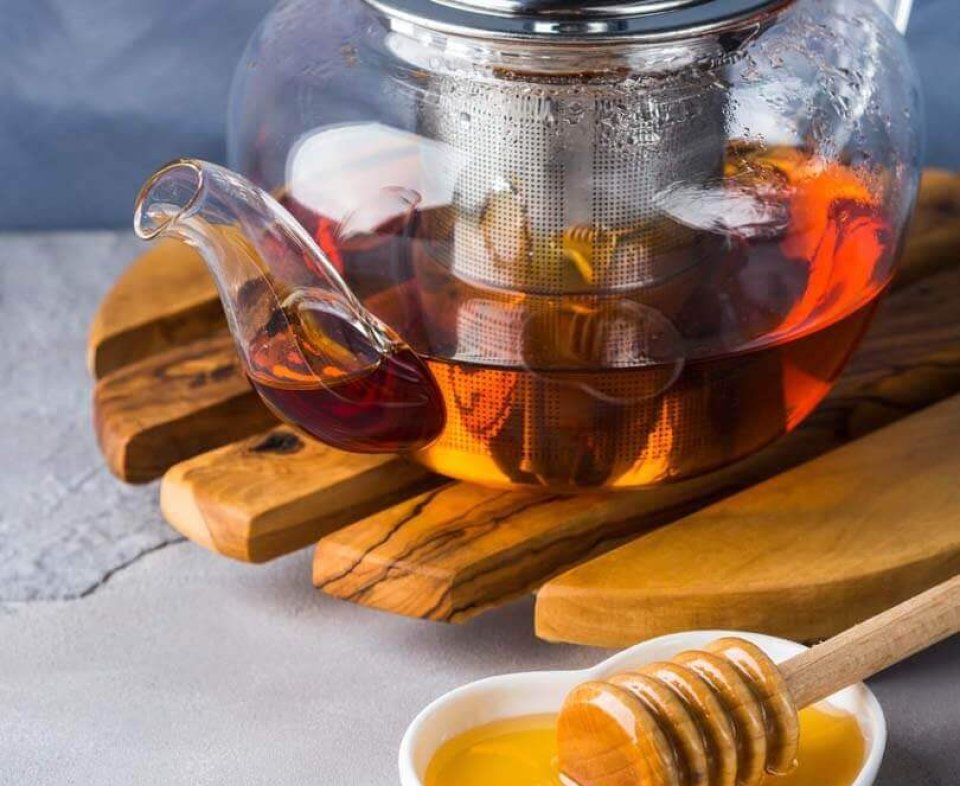 Teapot of red tea and honey